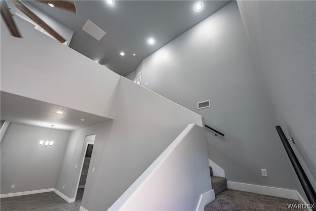 stairs with baseboards, recessed lighting, visible vents, and an inviting chandelier