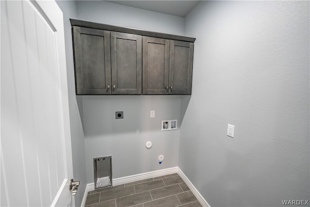 laundry area with hookup for a gas dryer, hookup for an electric dryer, washer hookup, baseboards, and cabinet space