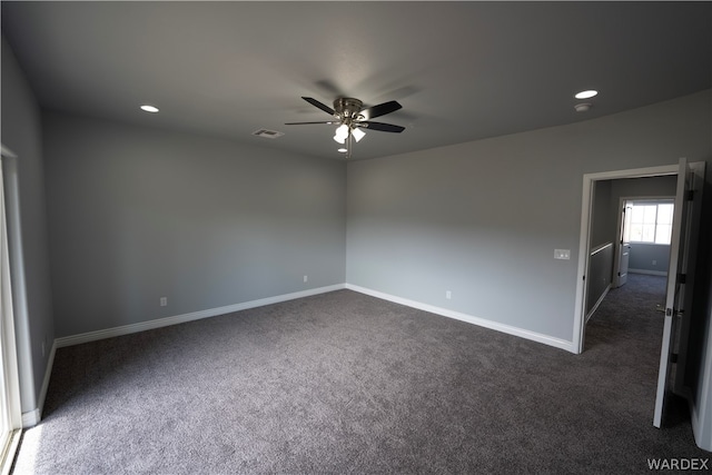 empty room with dark colored carpet, recessed lighting, visible vents, ceiling fan, and baseboards