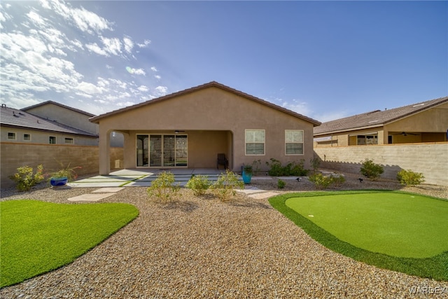 rear view of house featuring a patio, a fenced backyard, and stucco siding