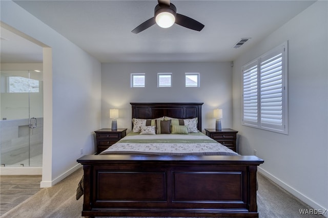 bedroom featuring light carpet, ensuite bathroom, visible vents, and baseboards