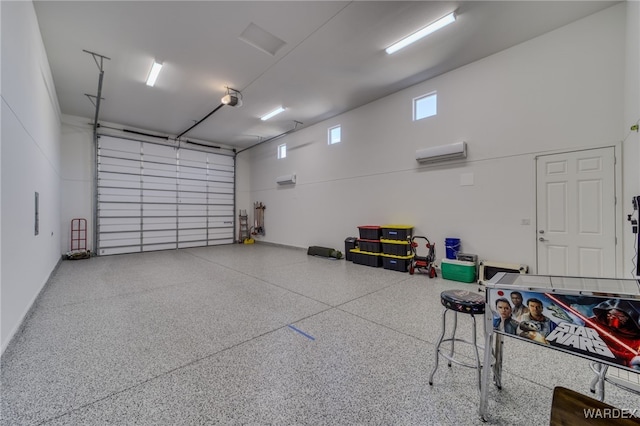 garage featuring a wall unit AC and a garage door opener