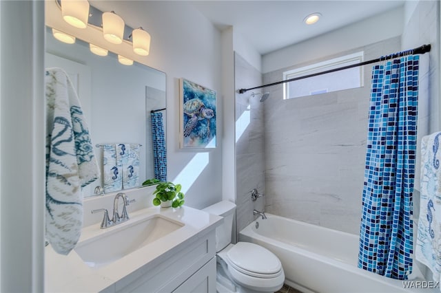 bathroom featuring toilet, shower / bath combo, and vanity