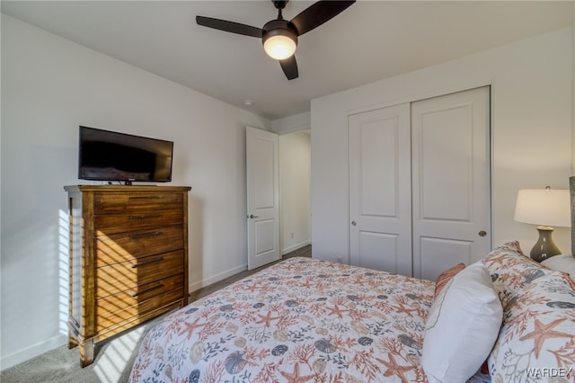 bedroom with a closet, carpet, a ceiling fan, and baseboards