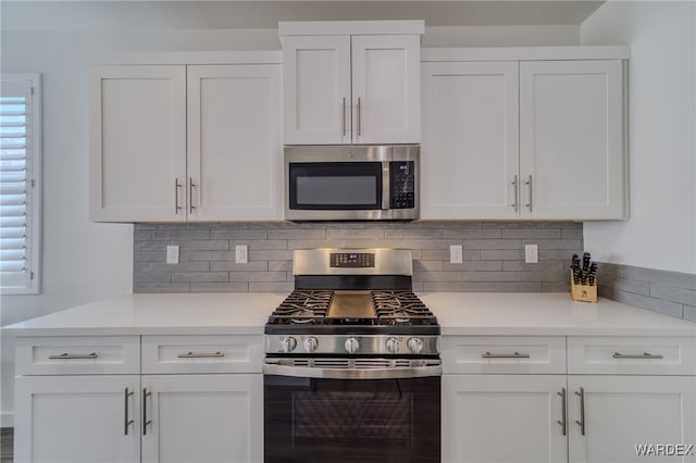 kitchen featuring light countertops, appliances with stainless steel finishes, and white cabinetry