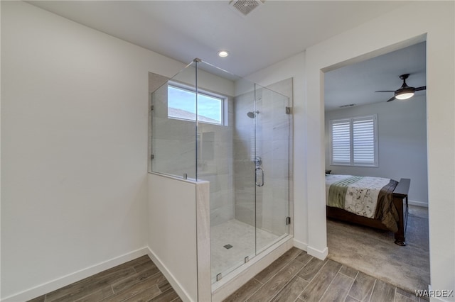 bathroom with wood tiled floor, a healthy amount of sunlight, and visible vents