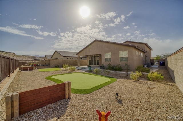 rear view of house with a patio, cooling unit, a fenced backyard, and stucco siding