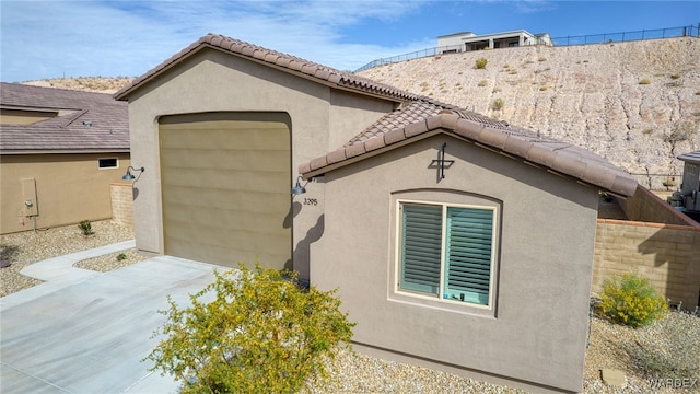 view of home's exterior with a tiled roof and stucco siding