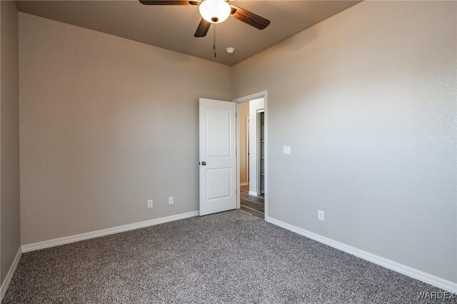 unfurnished room featuring carpet, baseboards, and a ceiling fan