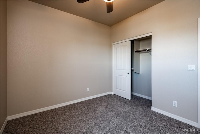 unfurnished bedroom featuring a closet, dark carpet, a ceiling fan, and baseboards