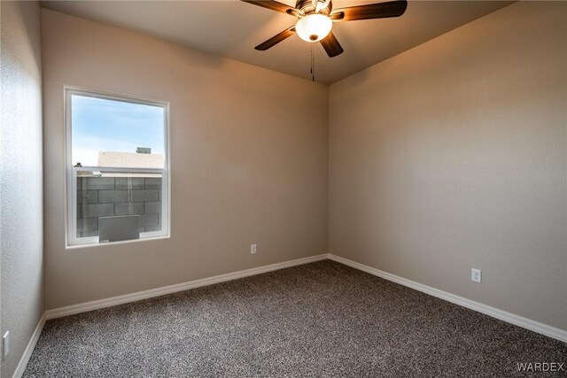 empty room featuring ceiling fan, baseboards, and carpet flooring