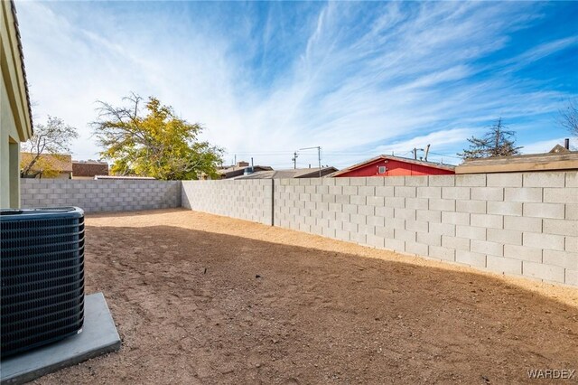 view of yard featuring central AC and a fenced backyard