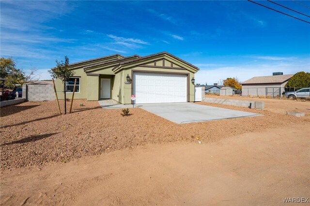 ranch-style house featuring driveway and an attached garage