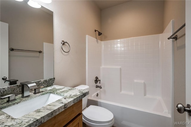 bathroom with toilet, vanity, and shower / tub combination