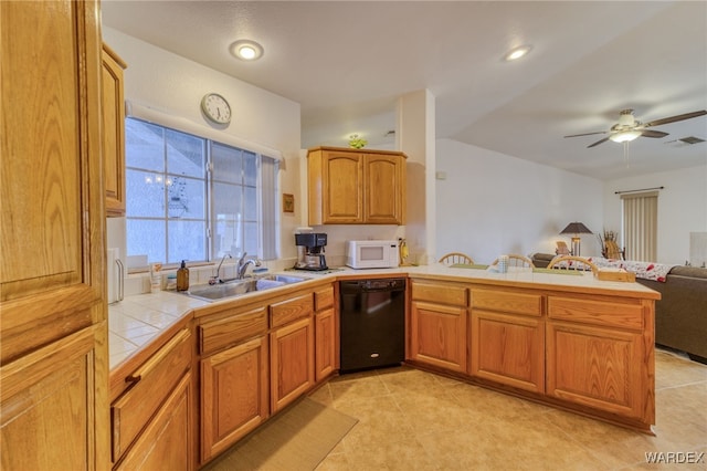 kitchen with black dishwasher, visible vents, tile counters, white microwave, and a sink