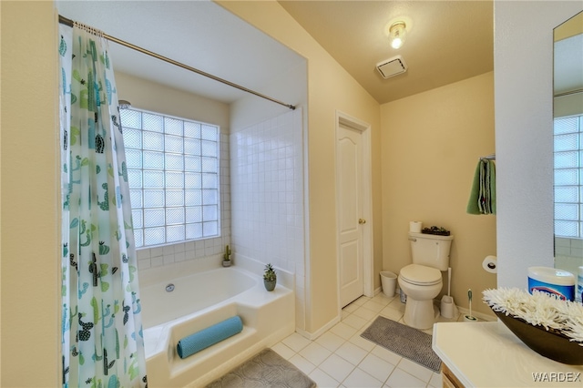 bathroom with baseboards, toilet, tile patterned flooring, a bathtub, and vanity