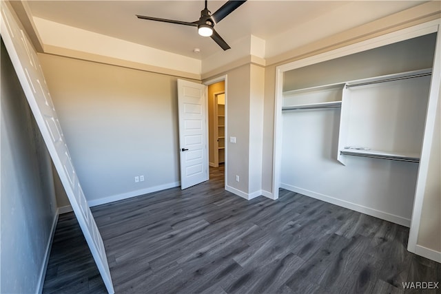 unfurnished bedroom with dark wood-type flooring, ceiling fan, and baseboards