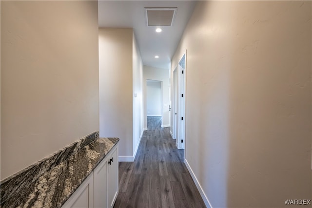 corridor featuring baseboards, visible vents, dark wood finished floors, and recessed lighting