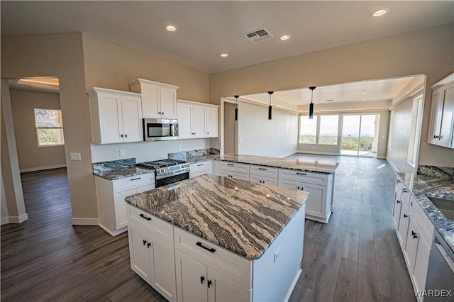 kitchen featuring white cabinets, visible vents, and stainless steel appliances