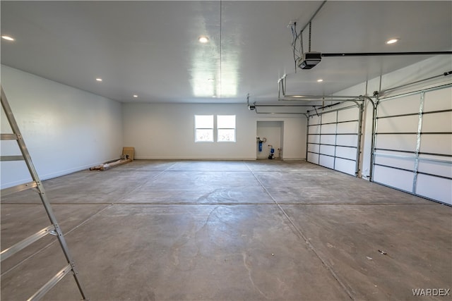 garage featuring baseboards, recessed lighting, and a garage door opener