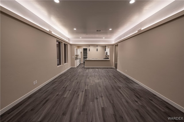 unfurnished living room featuring recessed lighting, dark wood-style flooring, visible vents, and baseboards