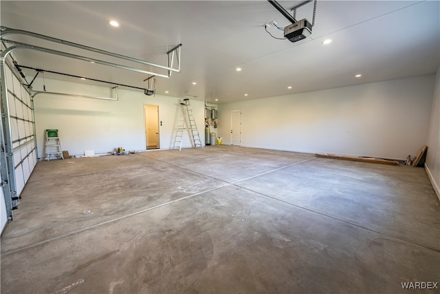 garage with a garage door opener and recessed lighting