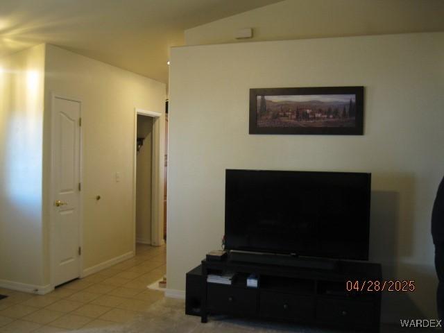 living area featuring baseboards and tile patterned flooring