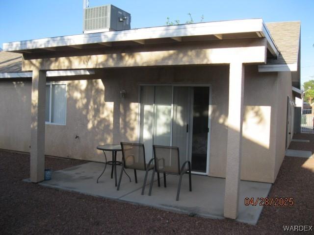 back of house featuring central air condition unit, stucco siding, and a patio area