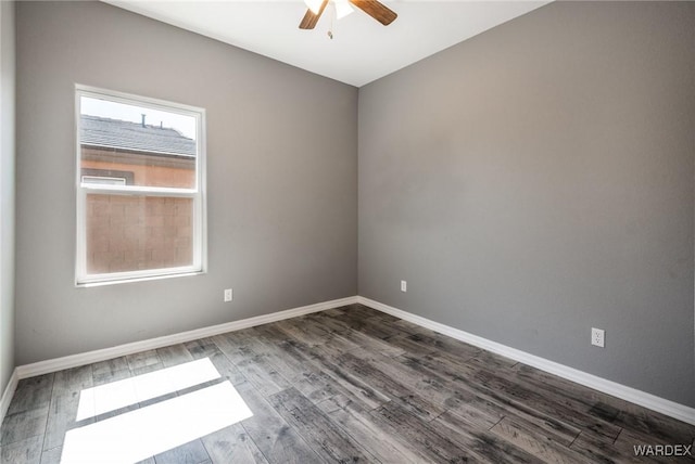 spare room with a ceiling fan, baseboards, and dark wood-style flooring