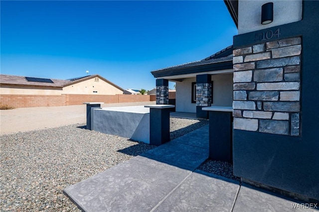 exterior space featuring fence and stucco siding