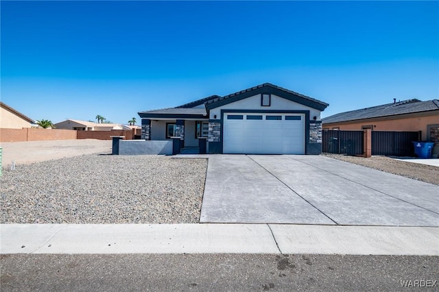 ranch-style home featuring a garage, driveway, fence, and stucco siding