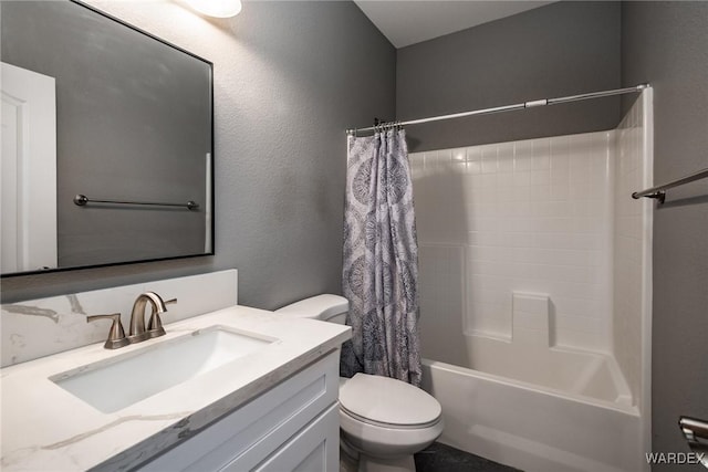 full bathroom with toilet, a textured wall, shower / bath combo with shower curtain, and vanity