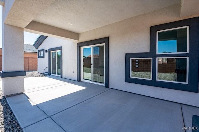 view of patio featuring fence