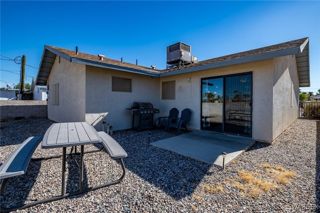 back of property featuring stucco siding, fence, a patio, and central air condition unit