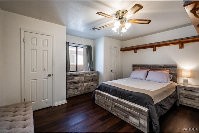 bedroom with ceiling fan, dark wood-style flooring, and visible vents