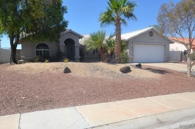 ranch-style house with an attached garage, concrete driveway, and stucco siding