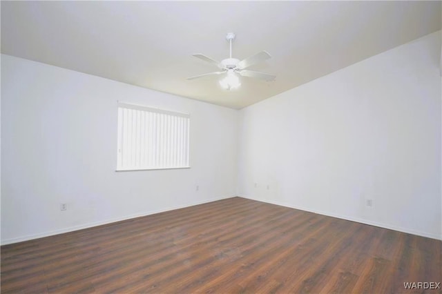 spare room with dark wood finished floors and ceiling fan