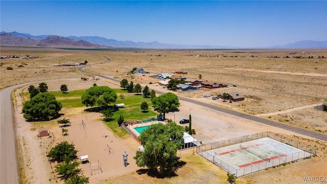 drone / aerial view with view of desert and a mountain view