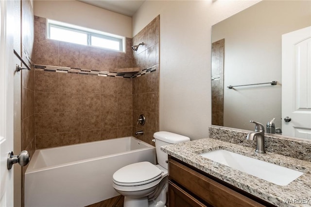 bathroom featuring bathing tub / shower combination, vanity, and toilet