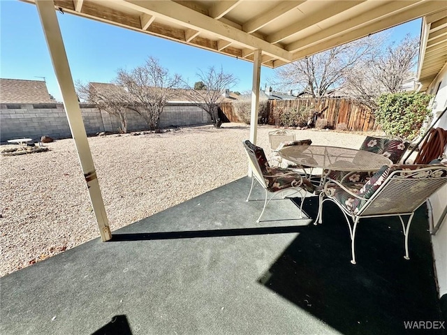 view of patio featuring outdoor dining area and a fenced backyard