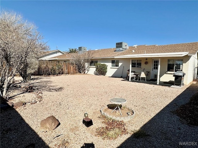 back of house featuring a patio, central AC unit, roof with shingles, and fence