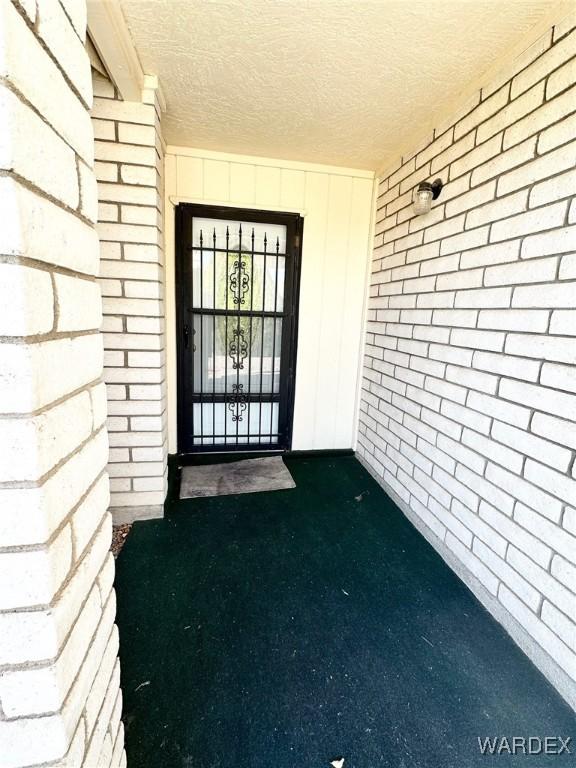 property entrance featuring brick siding