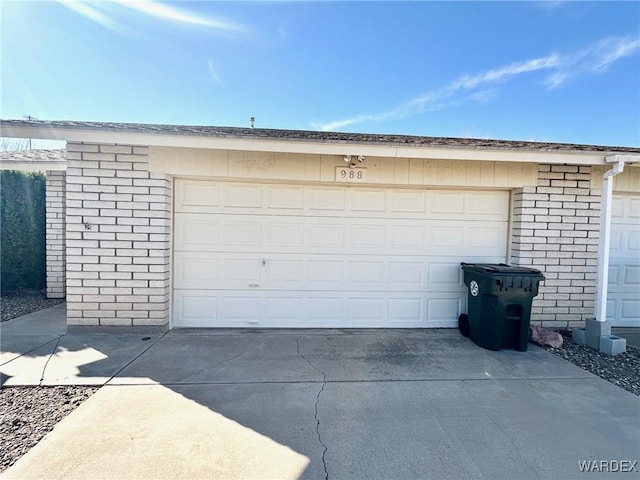 garage featuring concrete driveway