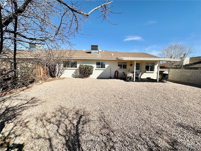 back of house with central air condition unit, a patio area, fence, and stucco siding