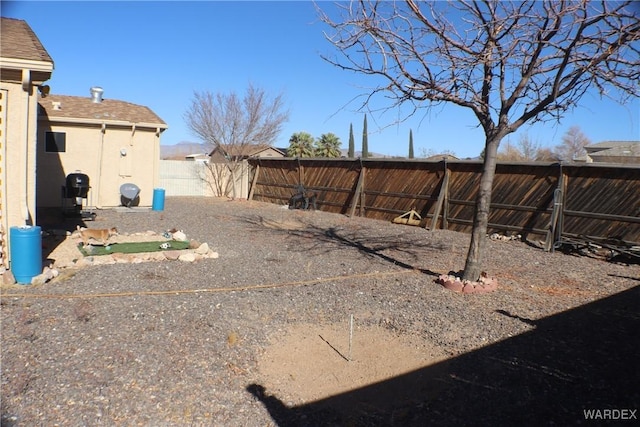 view of yard with a fenced backyard