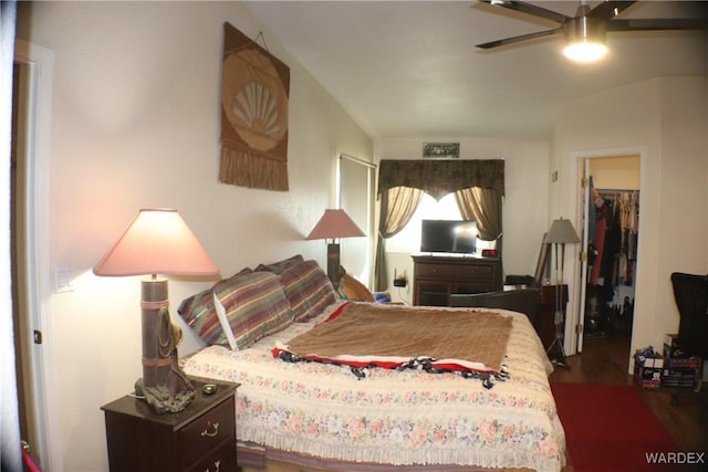 bedroom with ceiling fan and a spacious closet