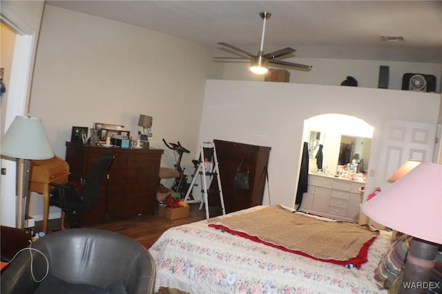 bedroom featuring dark wood-style floors, visible vents, and ensuite bathroom