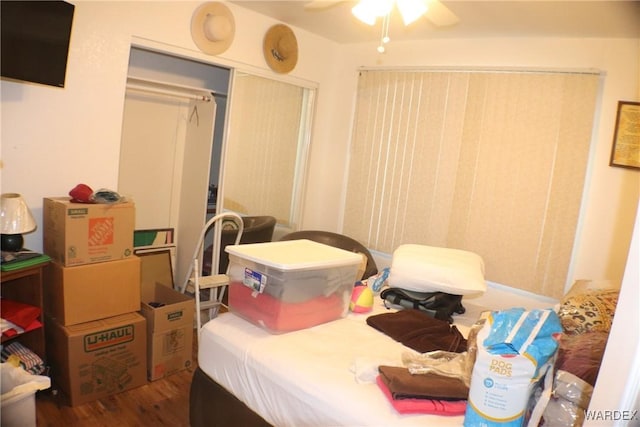 bedroom with ceiling fan, a closet, and dark wood-style flooring