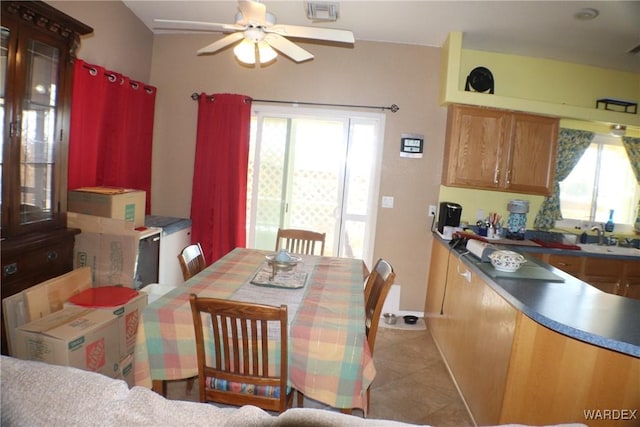 dining room featuring a ceiling fan, visible vents, plenty of natural light, and light tile patterned floors