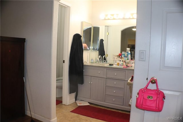 bathroom with toilet, tile patterned floors, and vanity